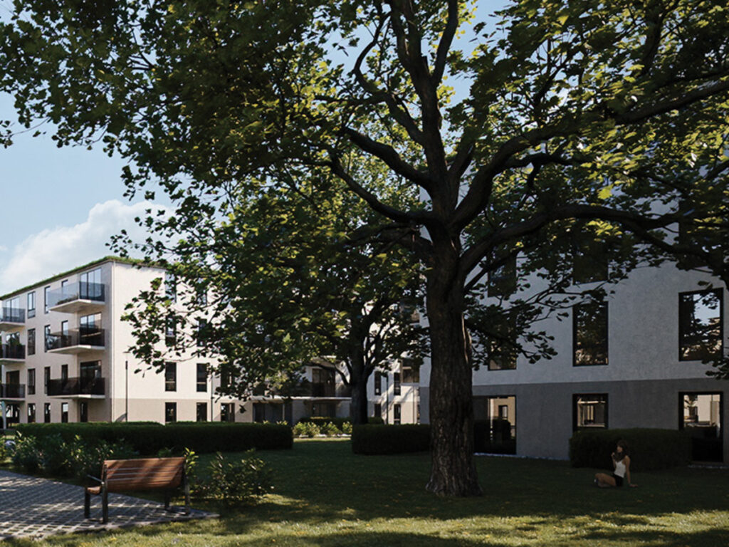 Moderne Wohngebäude mit Bäumen und Parkbank im Vordergrund.