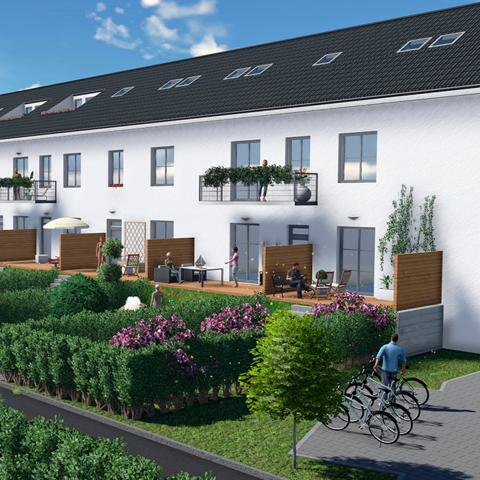 Reihenhäuser mit Gärten, Balkonen und Fahrradständern bei Sonnenschein.